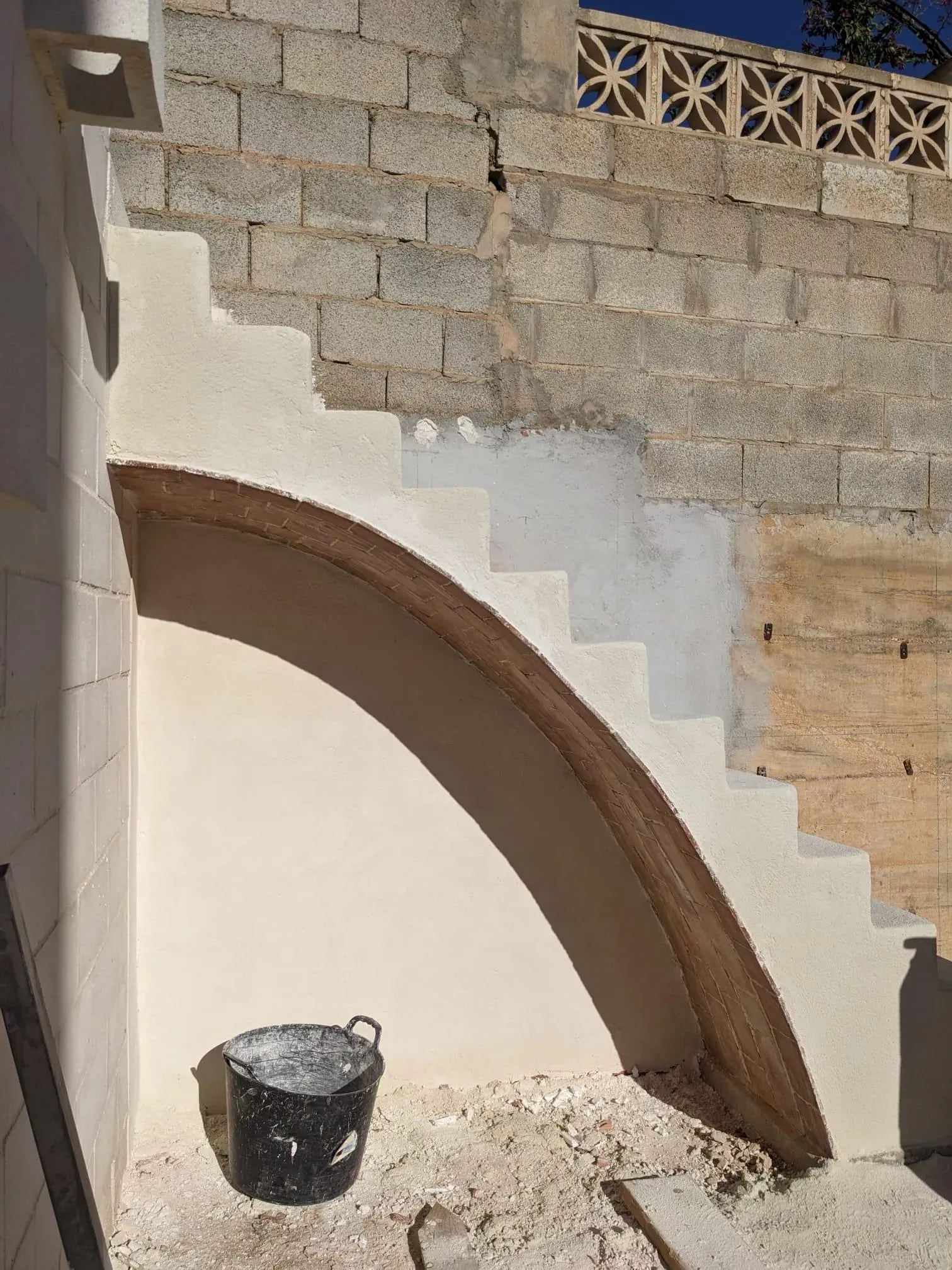 Proceso de revestimiento continuo en la escalera, suavizando las aristas del ladrillo