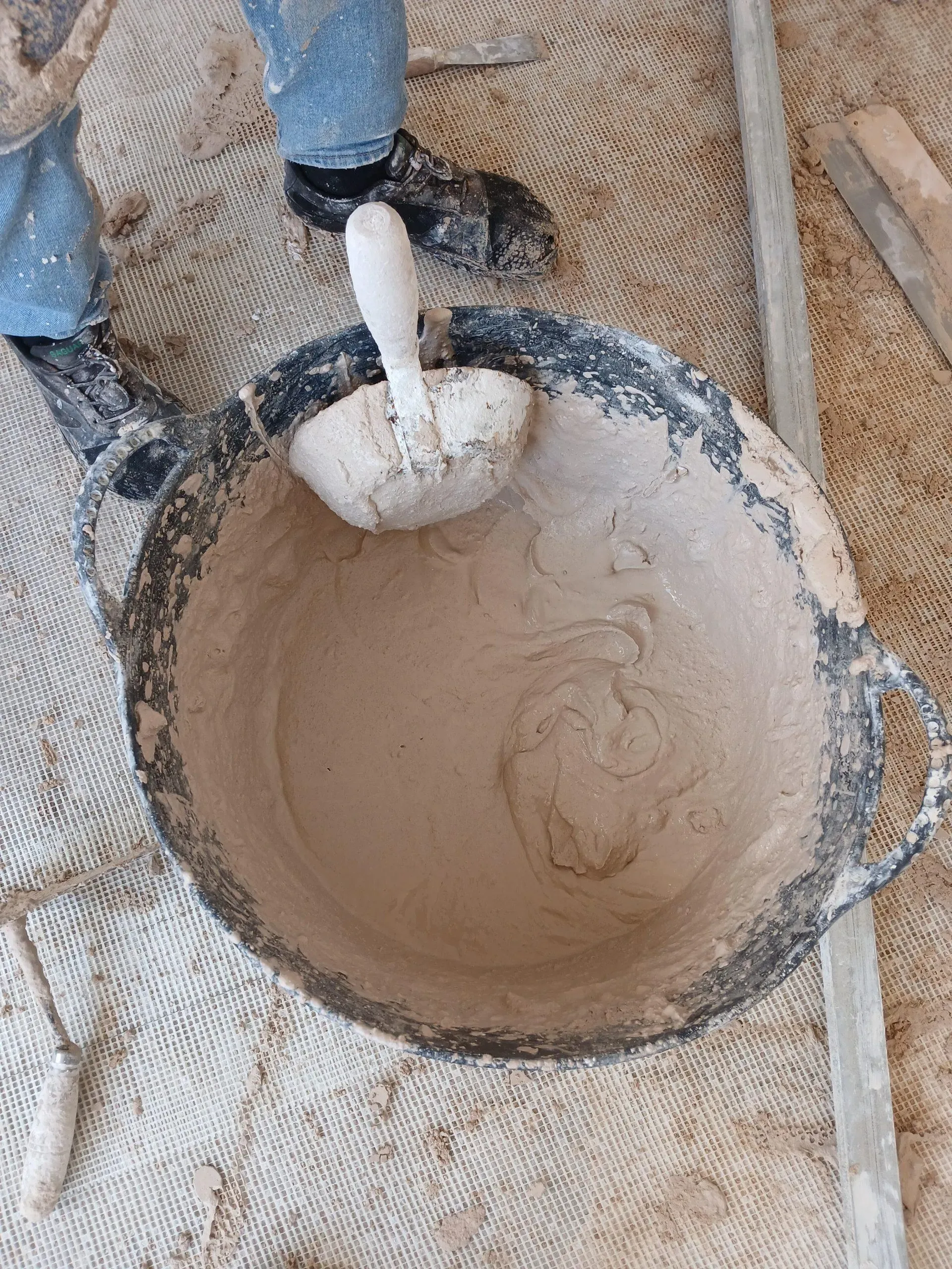 Tub with mortar mix ready for use, showing the workability of the material
