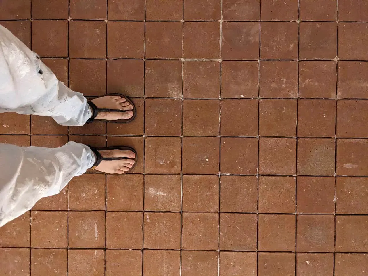 Bare feet on 15x15 square clay floor, feeling the natural texture